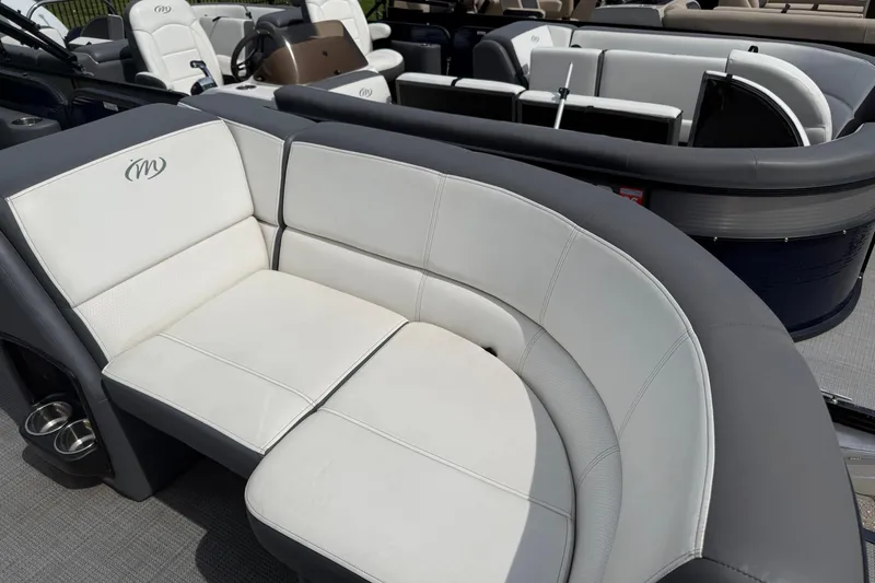 Slide: The Image of 2022 Manitou Aurora LE boat interior with plush seating and modern design. - 5