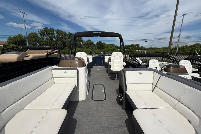Slide: The Image of 2022 Manitou Aurora LE pontoon boat interior with white seating and open deck layout. - 6