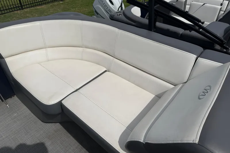 Slide: The Image of Luxurious seating on 2022 Manitou Aurora LE pontoon boat, featuring elegant white upholstery. - 7
