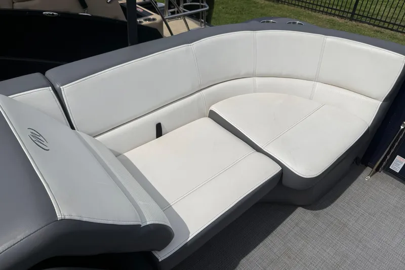 Slide: The Image of Luxurious seating on 2022 Manitou Aurora LE boat, featuring sleek white upholstery. - 8