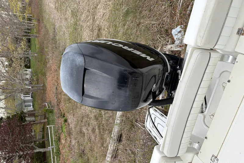 Slide: The Image of 2015 Mako 214 Center Console boat with Mercury outboard motor in grassy area. - 6