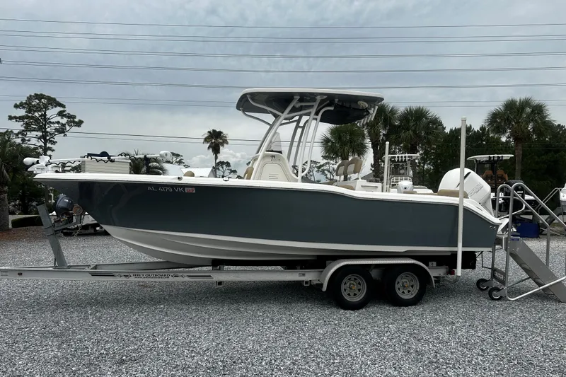 The Image of 2019 Key West 239 FS boat on trailer, parked outdoors with palm trees in background. - 1