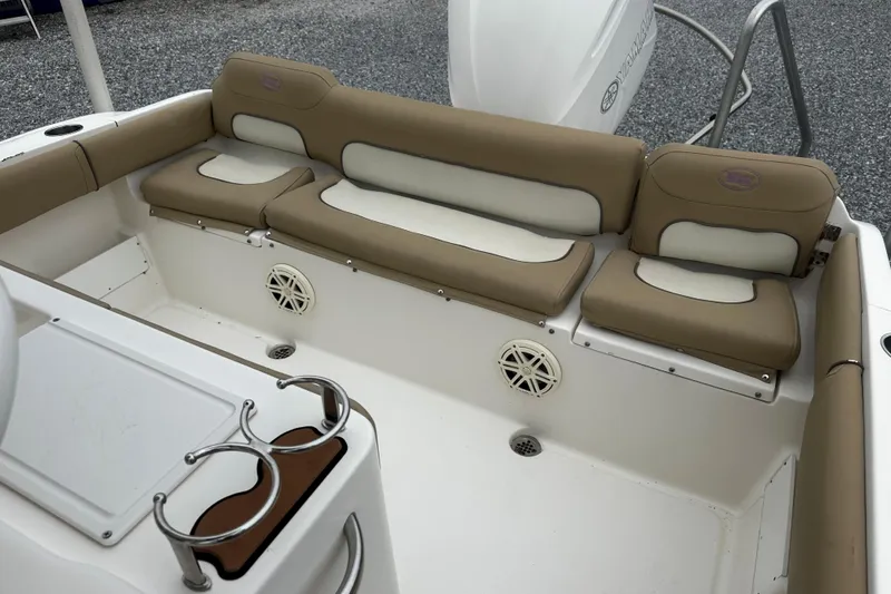 Slide: The Image of 2019 Key West 239 FS boat interior with tan and white cushioned seating. - 10