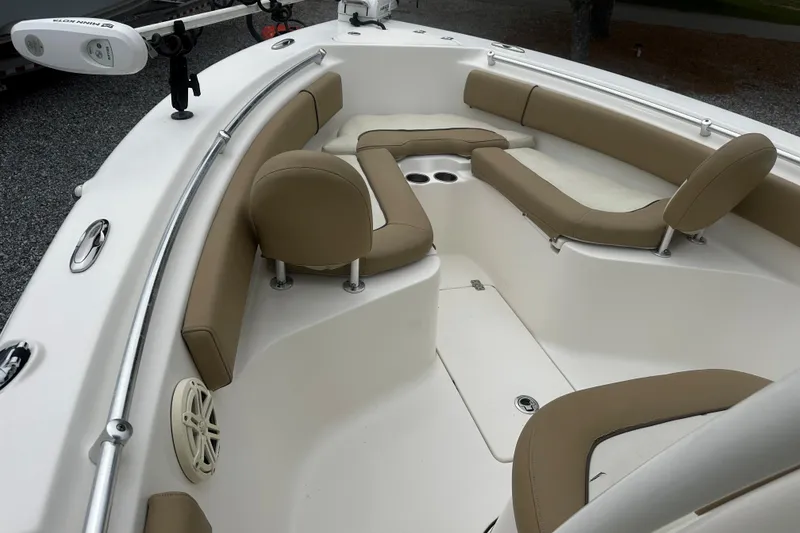 Slide: The Image of 2019 Key West 239 FS boat interior with tan seating and cup holders. - 11