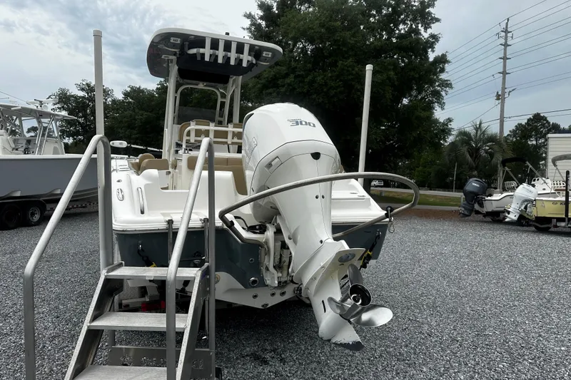 Slide: The Image of 2019 Key West 239 FS boat with powerful outboard motor, parked on gravel lot. - 3