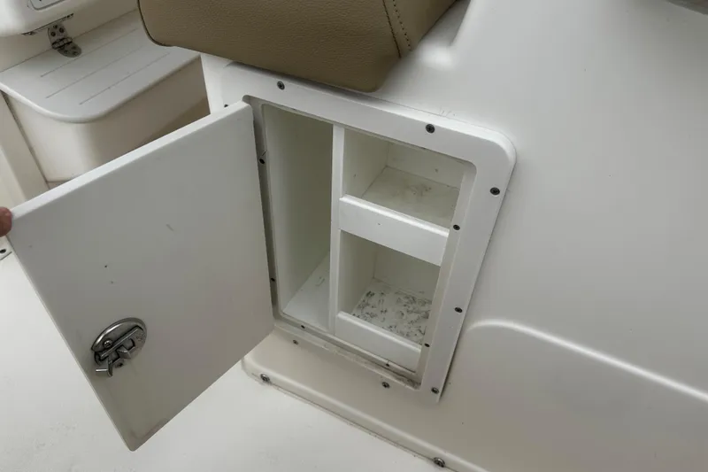 Slide: The Image of Open storage compartment on a 2019 Key West 239 FS boat, showcasing interior shelves. - 4