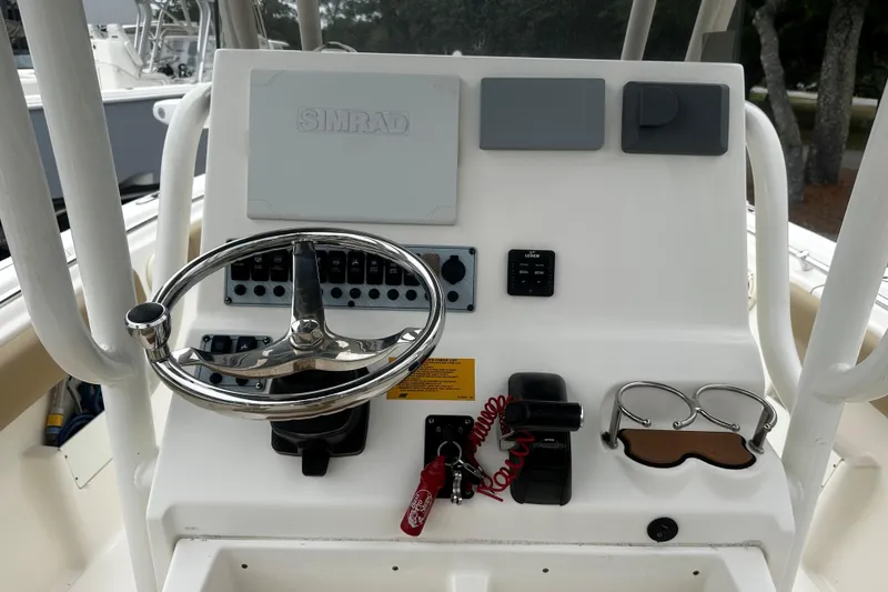Slide: The Image of 2019 Key West 239 FS boat console with steering wheel and controls. - 6