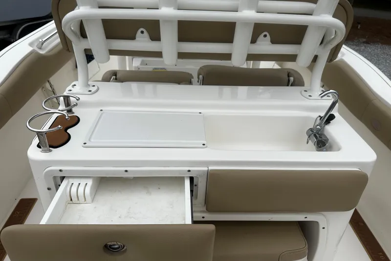 Slide: The Image of 2019 Key West 239 FS boat interior with sink, storage, and cup holders. - 8