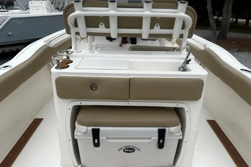 Slide: The Image of 2019 Key West 239 FS boat interior with seating, rod holders, and cooler. - 9