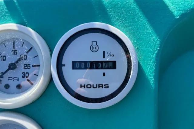 Slide: The Image of Close-up of 1971 Chrysler 15 CC dashboard gauges, showing PSI and hour meter readings. - 13