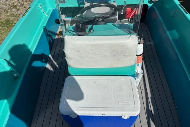 Slide: The Image of 1971 Chrysler 15 CC boat interior with steering console and cooler on deck. - 15