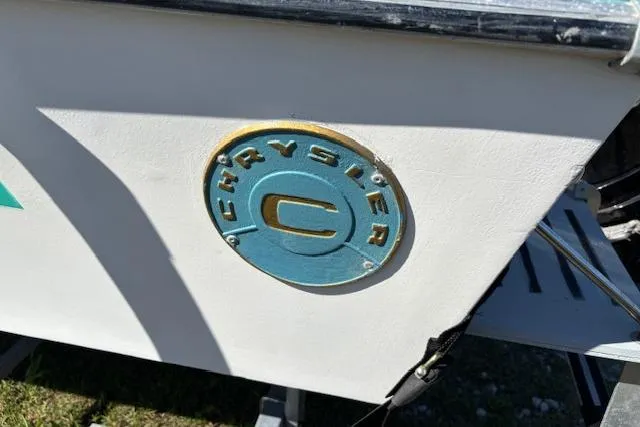 Slide: The Image of 1971 Chrysler 15 CC emblem on a white boat hull. - 17