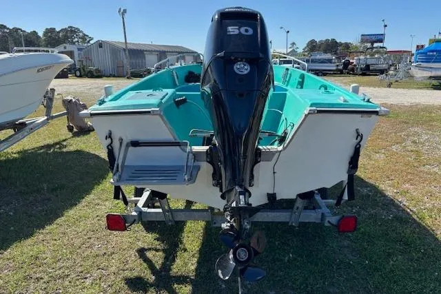 Slide: The Image of 1971 Chrysler 15 CC boat with 50 HP outboard motor on trailer, parked outdoors. - 4