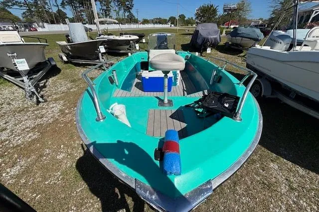 Slide: The Image of 1971 Chrysler 15 CC boat with turquoise deck, parked outdoors. - 8