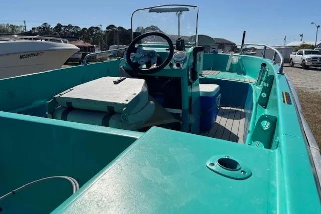 Slide: The Image of 1971 Chrysler 15 CC boat with turquoise interior, steering wheel, and seating area. - 9