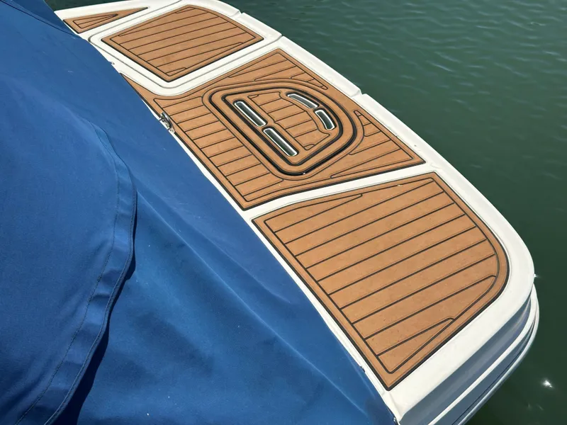 Slide: The Image of 2014 Sea Ray 260 Sundeck with blue cover and teak deck. - 13