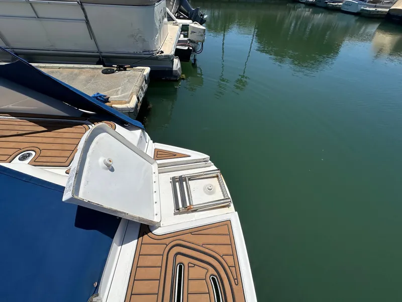Slide: The Image of 2014 Sea Ray 260 Sundeck at dock with wooden deck. - 22