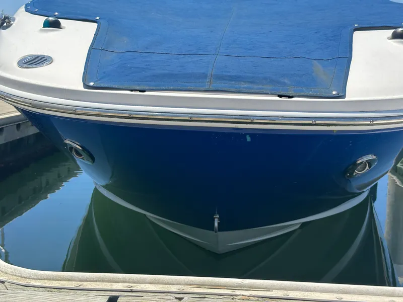 Slide: The Image of 2014 Sea Ray 260 Sundeck boat at dock, blue cover. - 32
