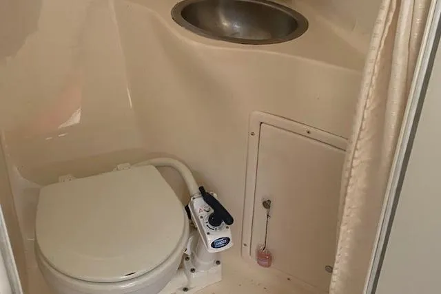 Slide: The Image of 2005 Rinker Fiesta Vee 250 boat bathroom with toilet and sink. - 6