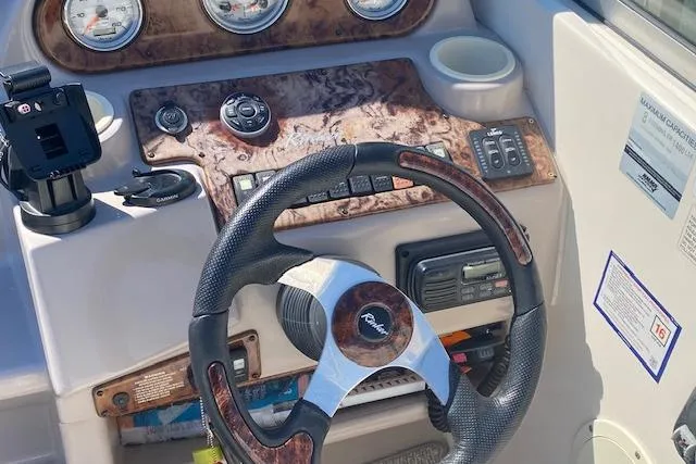 Slide: The Image of Steering wheel and dashboard of a 2005 Rinker Fiesta Vee 250 boat. - 7