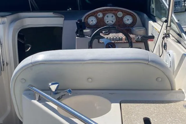 Slide: The Image of 2005 Rinker Fiesta Vee 250 boat interior with steering wheel and dashboard. - 8