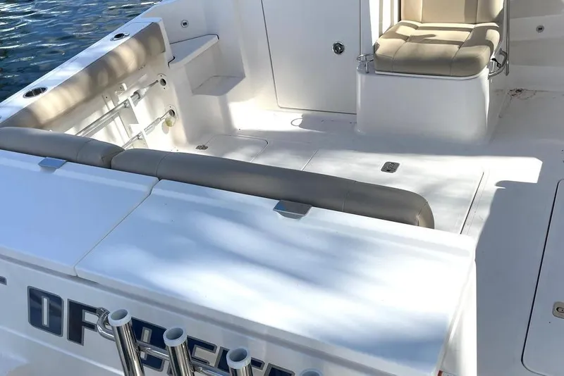Slide: The Image of 2016 Pursuit OS 325 Offshore boat interior with cushioned seating and storage compartments. - 3