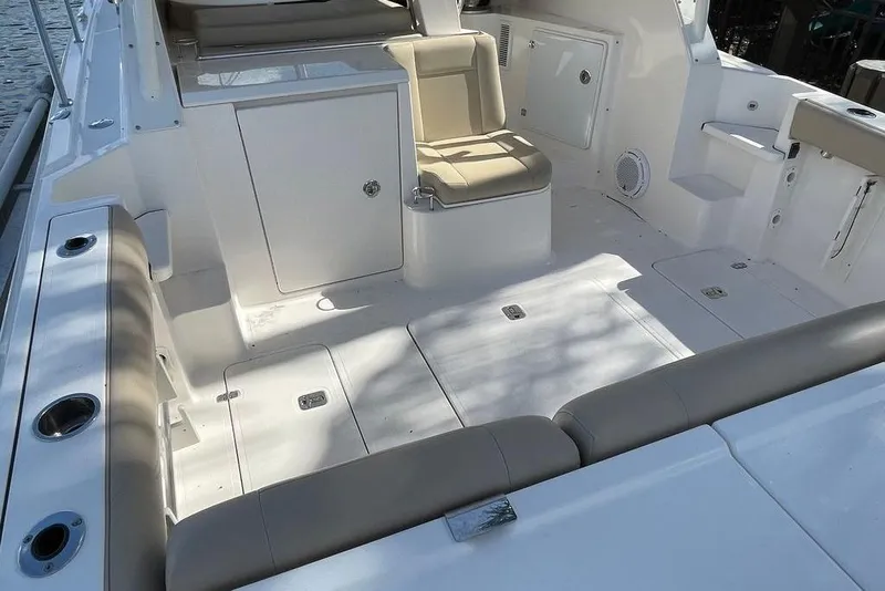 Slide: The Image of 2016 Pursuit OS 325 Offshore boat interior with seating and storage compartments. - 4