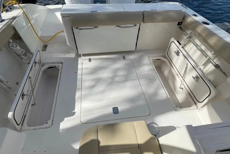 Slide: The Image of 2016 Pursuit OS 325 Offshore boat deck with open storage compartments. - 5