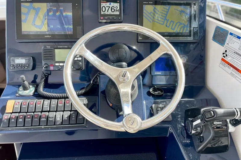 Slide: The Image of Helm of 2016 Pursuit OS 325 Offshore boat with navigation screens and controls. - 6