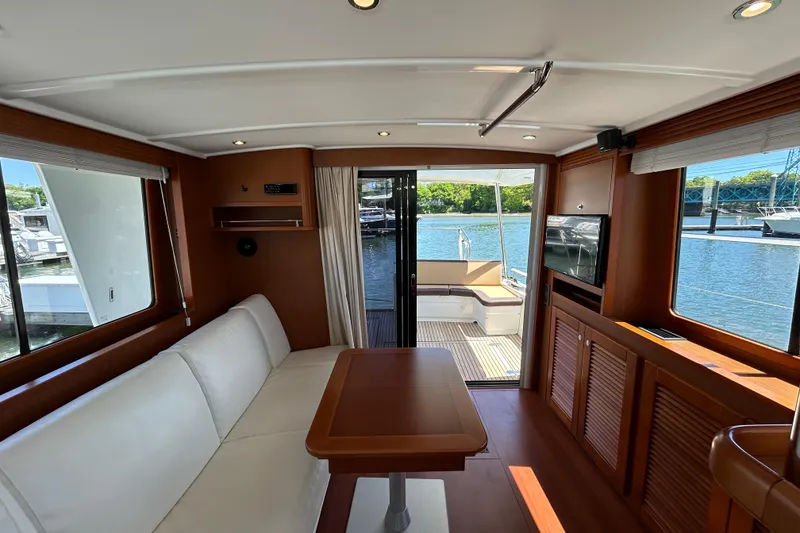 Slide: The Image of Interior of 2018 Beneteau Swift Trawler 44 with elegant seating and waterfront view. - 11