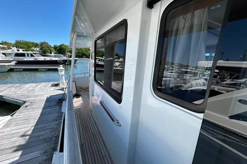 Slide: The Image of 2018 Beneteau Swift Trawler 44 docked, showcasing sleek exterior and marina view. - 16