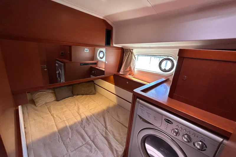 Slide: The Image of Cozy cabin interior of 2018 Beneteau Swift Trawler 44 with bed and washer. - 18