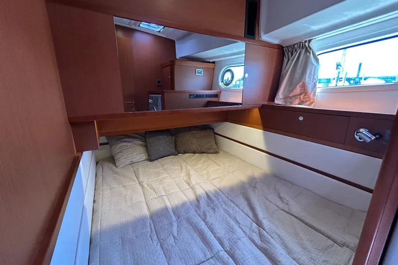 Slide: The Image of Cozy cabin interior of 2018 Beneteau Swift Trawler 44 with wooden finish and window view. - 19