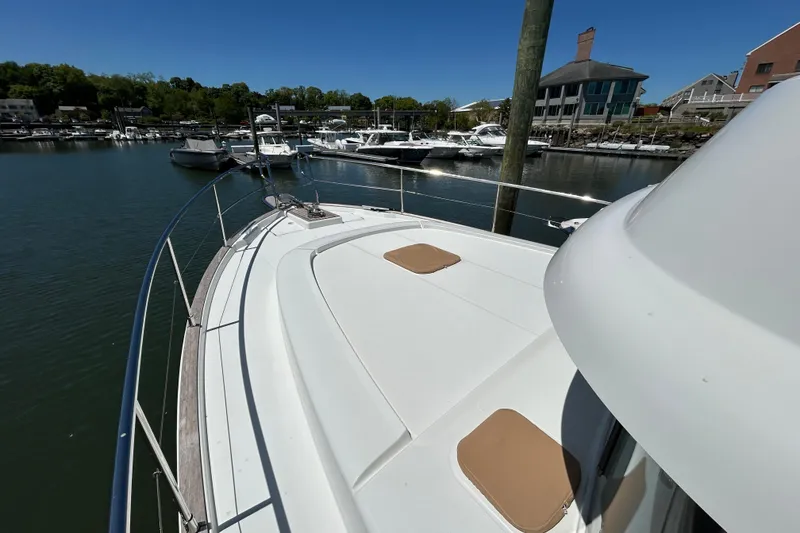 Slide: The Image of 2018 Beneteau Swift Trawler 44 docked in a marina under clear blue skies. - 28