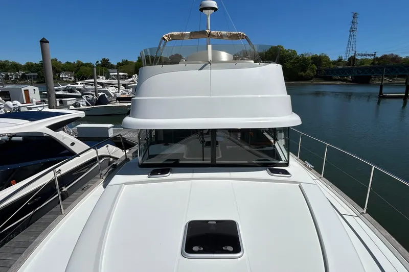 Slide: The Image of 2018 Beneteau Swift Trawler 44 docked, showcasing sleek design and spacious deck. - 29