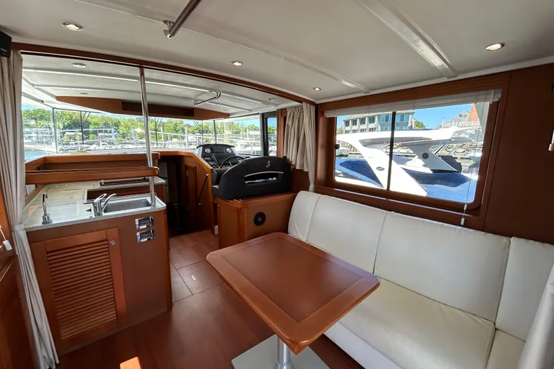 Slide: The Image of Interior of 2018 Beneteau Swift Trawler 44 with modern seating and kitchen area. - 7