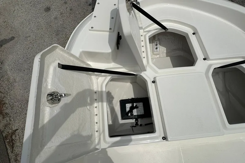 Slide: The Image of Open storage compartments on a 2026 Bayliner Trophy T18 boat deck. - 10