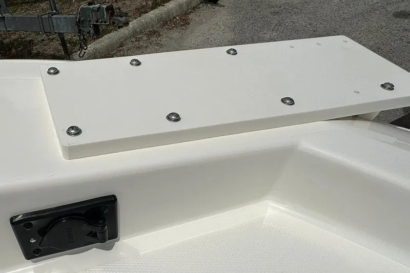 Slide: The Image of Bayliner Trophy T18 2026 boat deck detail with storage compartment and textured surface. - 11