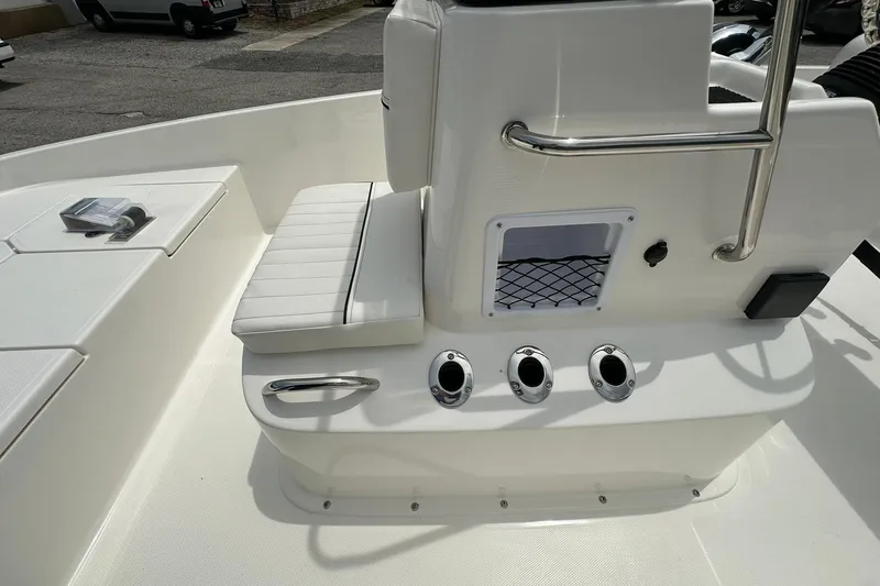 Slide: The Image of 2026 Bayliner Trophy T18 boat interior with white seating and control panel. - 12