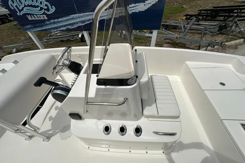 Slide: The Image of 2026 Bayliner Trophy T18 boat interior with steering console and seating. - 13