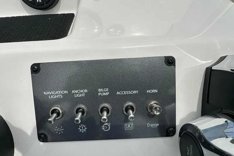 Slide: The Image of Control panel of 2026 Bayliner Trophy T18 with switches for navigation lights, anchor light, bilge pump, accessory, and horn. - 14