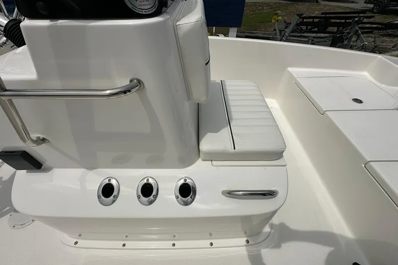 Slide: The Image of 2026 Bayliner Trophy T18 boat interior with white seating and stainless steel fixtures. - 15