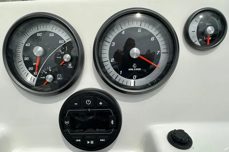 Slide: The Image of Dashboard of 2026 Bayliner Trophy T18 boat with speedometer, tachometer, and Bluetooth controls. - 17