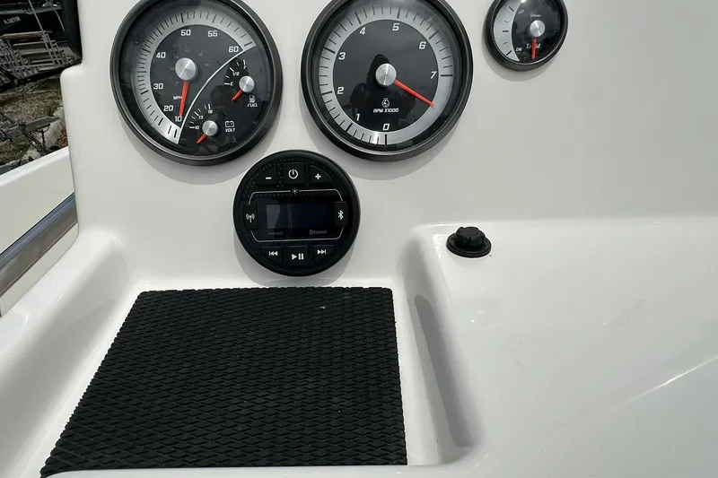 Slide: The Image of Dashboard of 2026 Bayliner Trophy T18 boat with gauges and controls. - 18