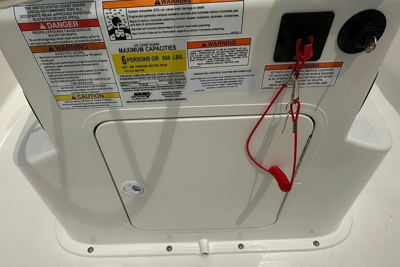 Slide: The Image of 2026 Bayliner Trophy T18 boat safety warnings and capacity labels on deck. - 19