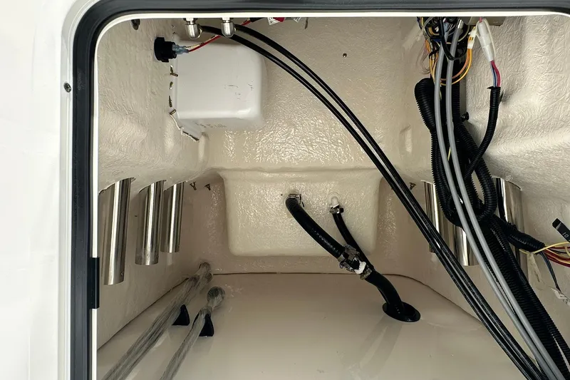 Slide: The Image of Interior view of 2026 Bayliner Trophy T18 boat compartment with wiring and storage. - 21
