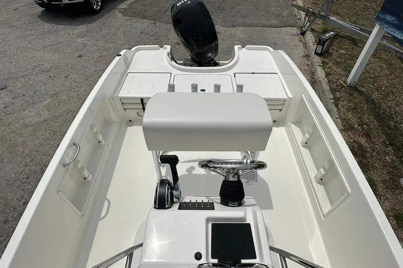 Slide: The Image of 2026 Bayliner Trophy T18 boat interior with steering console and seating. - 25
