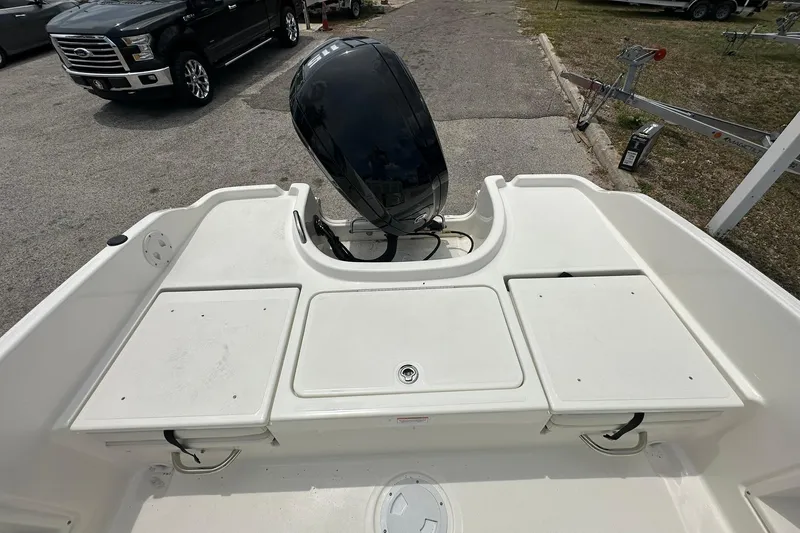Slide: The Image of 2026 Bayliner Trophy T18 boat with outboard motor, parked on a trailer. - 26
