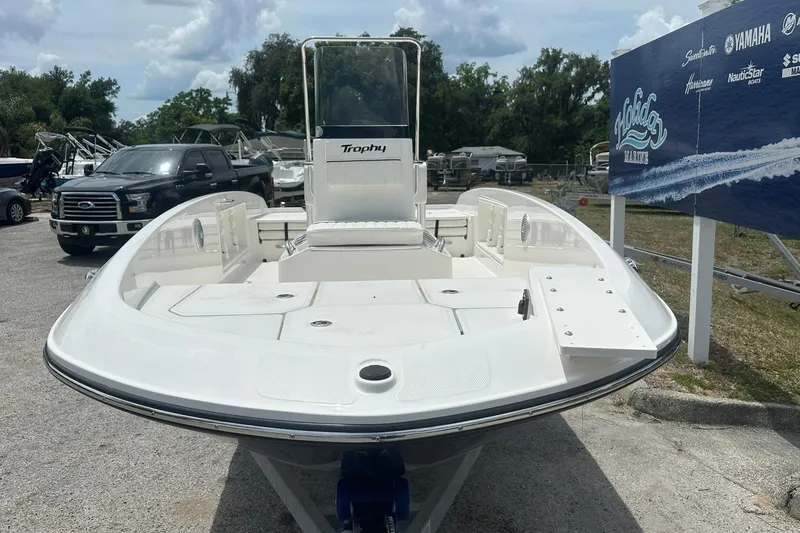 Slide: The Image of 2026 Bayliner Trophy T18 boat displayed outdoors at a dealership. - 3