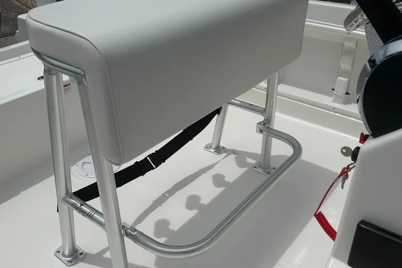 Slide: The Image of 2026 Bayliner Trophy T18 boat interior with cushioned seating and metal frame. - 30